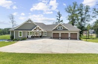 a home with two garages and a driveway